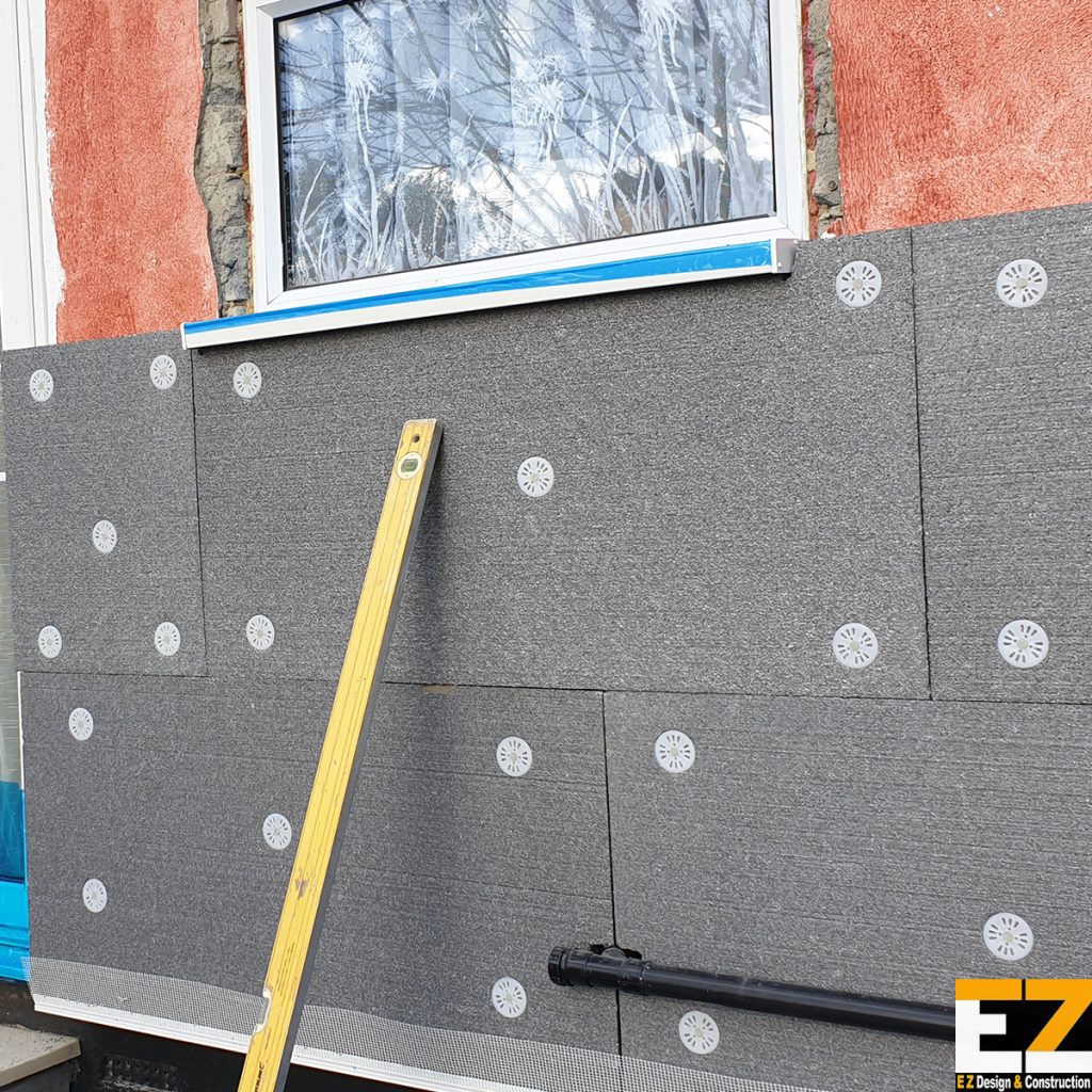 External Wall Insulation Installers Sidcup fixing insulation boards to solid wall property during installation